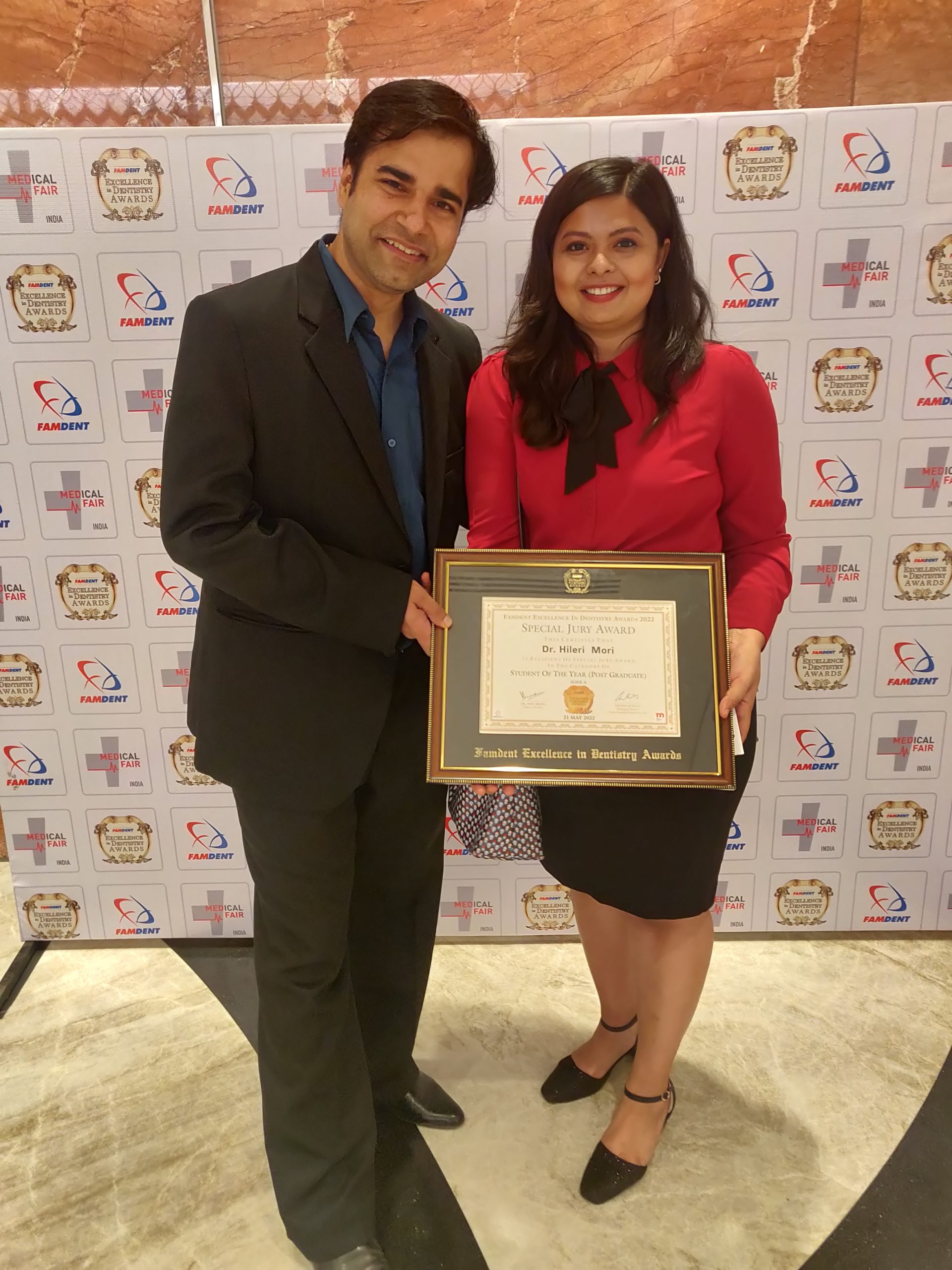 Dr. Hileri Mori at the Famdent Excellence in Dentistry Awards ceremony showcasing academic and professional achievements in dentistry.
